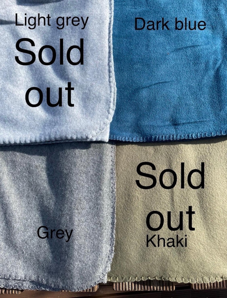 May include: Four fabric swatches in light grey, dark blue, grey, and khaki. The light grey and khaki swatches are labelled with the text 'Sold out'. Each swatch features a finished edge with visible stitching along the border.