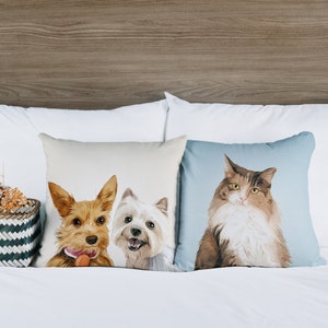May include: Three throw pillows with pet portraits. The left pillow features a brown and white dog with a red toy. The middle pillow features a white dog with black ears. The right pillow features a brown and white cat with blue eyes.
