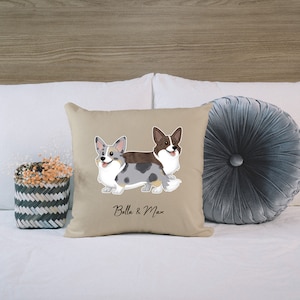 May include: Beige pillow with a cartoon illustration of two corgis, one blue and white and one brown and white. The text "Bella & Max" is printed below the dogs.