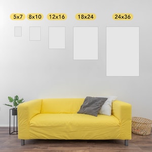 May include: A white wall with six different sized rectangular frames, labeled with their dimensions in inches. The frames are arranged in a row from smallest to largest. A yellow sofa with a gray and white pillow sits in front of the wall.