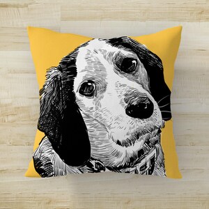 May include: A yellow throw pillow with a black and white illustration of a dog's head. The dog is looking to the left and has floppy ears.