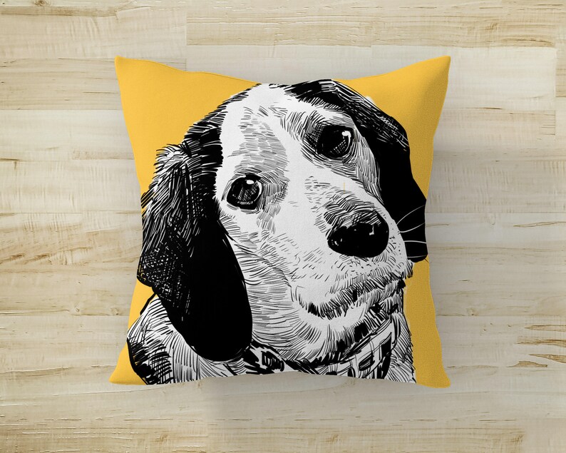 May include: A yellow throw pillow with a black and white illustration of a dog's head. The dog is looking to the left and has floppy ears.