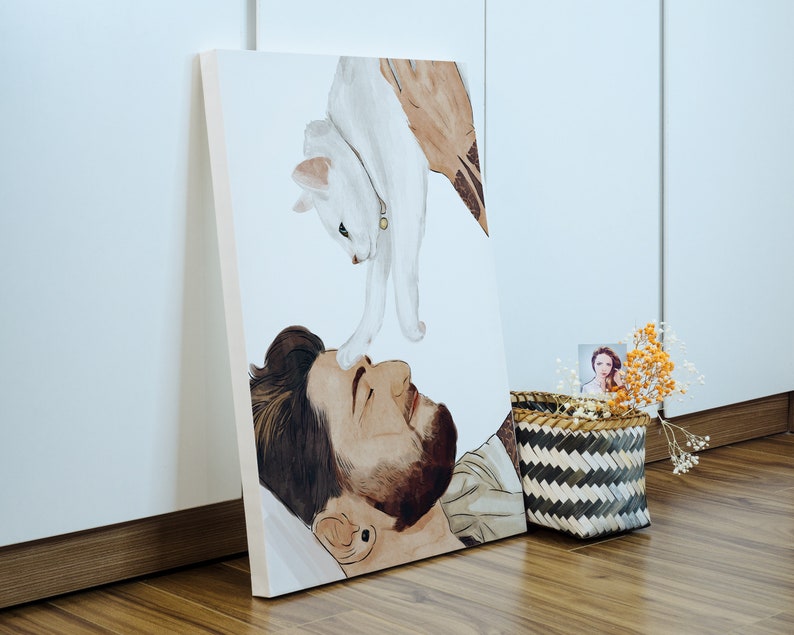 K&ouml;nnte beinhalten: Ein Aquarellbild einer Person mit einer wei&szlig;en Katze auf der Brust. Die Katze schaut auf die Person, die die Katze anschaut. Das Bild ist auf Leinwand gemalt und gerahmt.