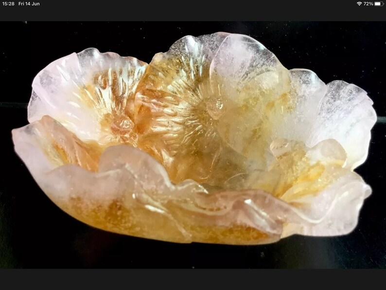 May include: A delicate, hand-carved flower bowl made of translucent pink and gold quartz. The bowl features intricate details and a delicate, feminine design.
