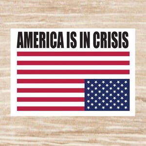 May include: A white sticker with a red, white, and blue American flag with the text "AMERICA IS IN CRISIS" printed in black.