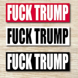 May include: Three rectangular stickers with the text "FUCK TRUMP" in bold white letters. The top sticker has a red background, the middle one has a white background, and the bottom one has a black background.