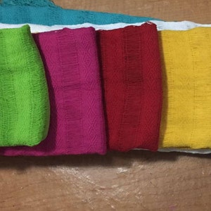 May include: A set of ten colorful fabric squares, including blue, purple, green, pink, red, yellow, white, and turquoise.