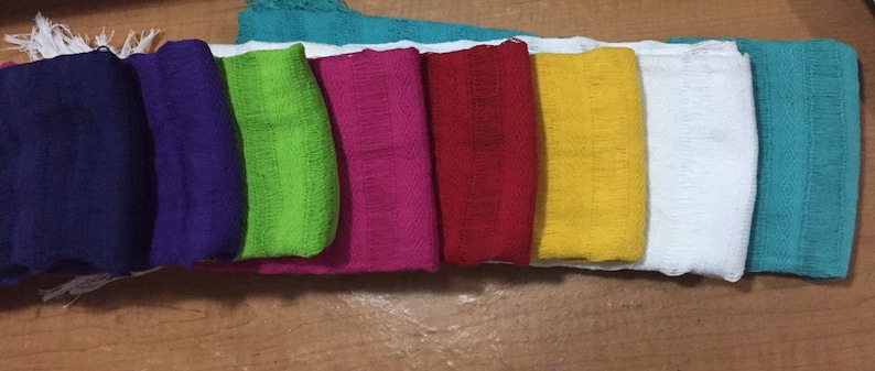 May include: A set of ten colorful fabric squares, including blue, purple, green, pink, red, yellow, white, and turquoise.