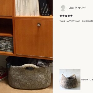 Felted wool storage basket in grey with two wrapped handles; cozy cat bed with a sleeping cat inside.