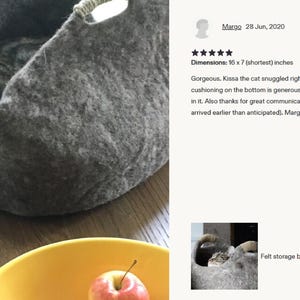 Felted wool storage basket in grey with two wrapped handles; cozy cat bed with a sleeping cat inside.