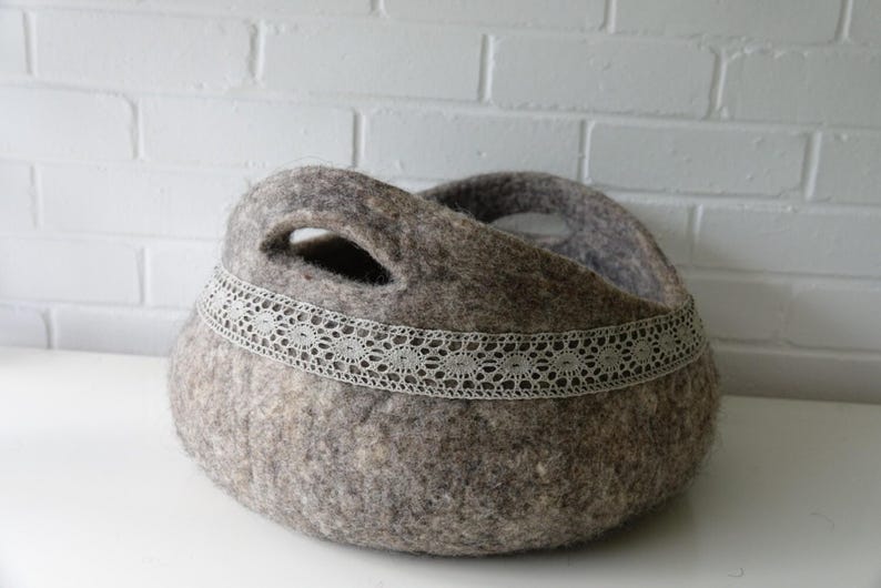 Felted storage basket with linen lace trim and handles; neutral brown felt, ideal as magazine bin or cat bed.