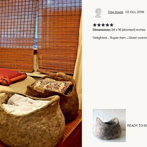Felted wool storage basket in grey with two wrapped handles; cozy cat bed with a sleeping cat inside.