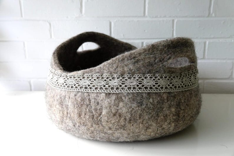 Felted storage basket with linen lace trim and handles; neutral brown felt, ideal as magazine bin or cat bed.