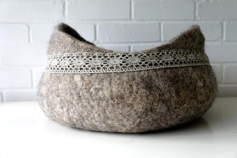 Felted storage basket with linen lace trim and handles; neutral brown felt, ideal as magazine bin or cat bed.