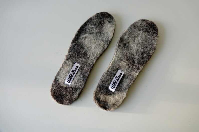 Wool shoe insoles, natural undyed felted wool, unisex warm boot inserts with white brand tags.