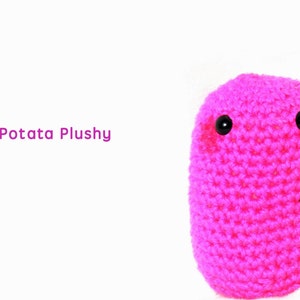May include: A pink crocheted plush toy shaped like a potato with black button eyes. The toy is called "Tiny Potata Plushy".