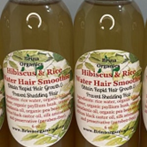 May include: Two clear plastic bottles filled with a light brown liquid hair treatment. Each bottle has a white cap and a label reading Bruna Organics Hibiscus & Rice Water Hair Smoothie, Obtain Rapid Hair Growth & Prevent Shedding Hair, 6 oz.
