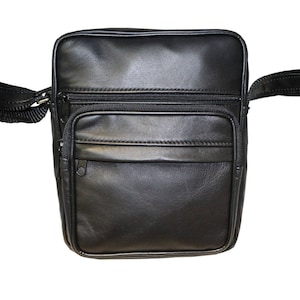 May include: A black leather crossbody bag with a zippered pocket on the front and a long adjustable strap.