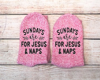 May include: A pair of pink socks with the text "Sundays are for Jesus & Naps" printed on them.