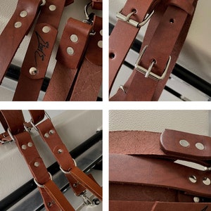 May include: Brown leather camera strap with silver hardware and the word "Story" embossed on the strap.