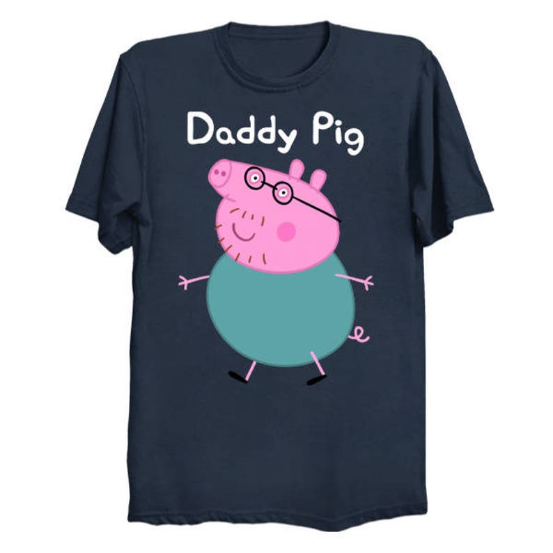 May include: A navy blue t-shirt with the text "Daddy Pig" printed in white. A cartoon pig wearing glasses and a blue shirt is printed on the shirt.