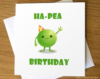 May include: A white card with green text that says "HA-PEA BIRTHDAY". A green pea with a party hat and a smile is waving.