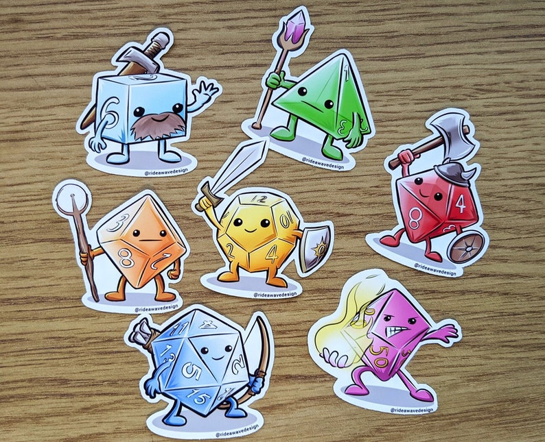 May include: A collection of colorful, cartoon-style dice stickers, each with a unique design and expression. The dice are various shapes, including cubes, pyramids, and multi-sided dice, with weapons and accessories. The stickers are on a wooden surface.