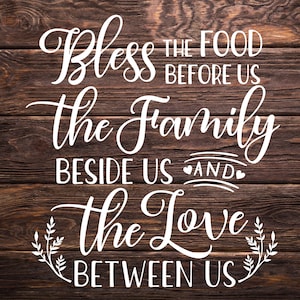 May include: White text on a brown wooden background reads "Bless the food before us, the family beside us and the love between us".