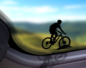 May include: Silhouette of a person riding a mountain bike on a blurred background of a landscape with a blue sky.