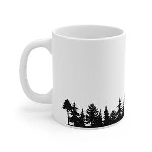 May include: White ceramic mug with a black silhouette of a forest tree line at the bottom.