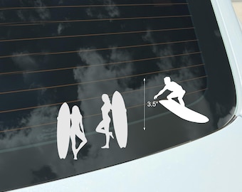 May include: White vinyl decal featuring three surfer silhouettes and a surfer riding a wave. The decal includes two female figures with surfboards and a male figure surfing. The height of the decal is 3.5 inches.