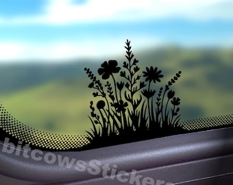 May include: A black vinyl decal featuring a silhouette of various wildflowers and grasses, applied to a glass surface. The design includes diverse floral shapes and stems. The text bitcowsStickers.com is visible in white at the bottom.