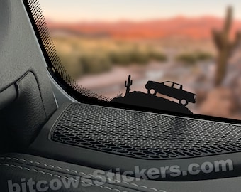 May include: Black silhouette decal of a truck driving up a hill with a cactus in the background. The decal is on a car window. "bitcowsStickers.com" and "Approximate Size 3" are printed below the decal.