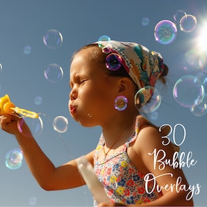May include: A young person blowing bubbles with a yellow toy bubble blower. The person is wearing a colorful headband and a floral sundress. There are many colorful bubbles floating in the air. The text "30 Bubble Overlays" is written in white on the image.