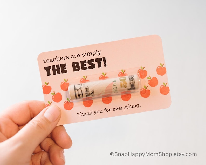 May include: A pink card with a red apple pattern and the text "teachers are simply THE BEST!"  A rolled up $50 bill is inside a clear plastic sleeve on the card. The text "Thank you for everything." is below the bill.