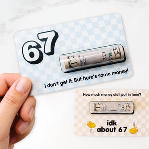 May include: Two gift cards with money. One card has a blue and white checkered pattern with the number 67 and the text "I don't get it. But here's some money!". The other card has a tan and white checkered pattern with the text "How much money did I put in here?" and "idk about 67".