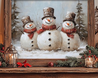 May include: A framed winter scene painting of three snowmen with red scarves and black top hats. The snowmen are standing in front of a snowy forest. The painting is on a wooden table with a Christmas tree and other decorations.