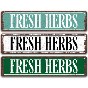 three rectangular signs with the text "FRESH HERBS" written on them in different colors.