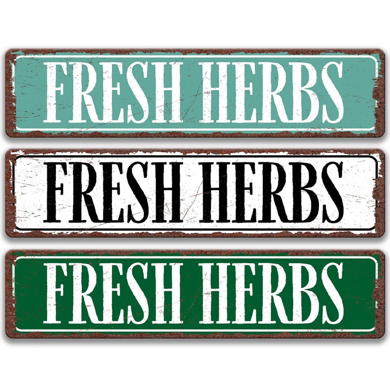 three rectangular signs with the text "FRESH HERBS" written on them in different colors.