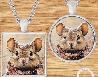 May include: Two silver-toned necklaces with pendants featuring a mouse illustration. One pendant is square, the other is round. The mouse has brown fur, large ears, and wears a red and brown scarf. The background is a neutral beige.