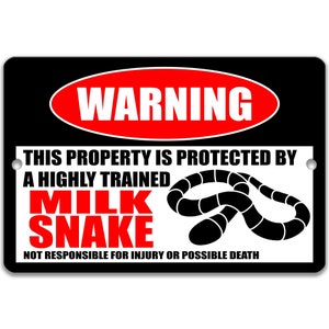 May include: Black and white warning sign with red text that reads "WARNING". The sign says "This property is protected by a highly trained milk snake. Not responsible for injury or possible death." A black and white image of a milk snake is on the sign.