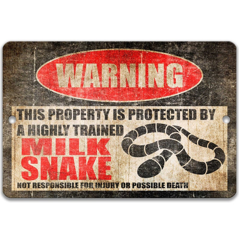 May include: A warning sign with a red circle and the word "WARNING" in white letters. The sign reads "This property is protected by a highly trained milk snake. Not responsible for injury or possible death." The sign has a distressed, vintage look.