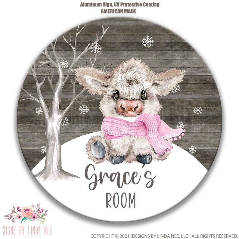 May include: A round wooden sign with a white background featuring a cartoon highland cow wearing a pink scarf. The sign has the text "Grace's Room" in black lettering.