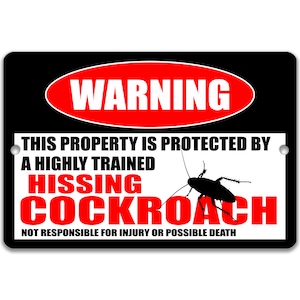 May include: A black and white warning sign with red text that reads "WARNING" in a red oval. The sign says "This property is protected by a highly trained hissing cockroach. Not responsible for injury or possible death." A silhouette of a cockroach is shown on the sign.