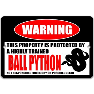May include: A black and white warning sign with red text that reads "WARNING". The sign says "This property is protected by a highly trained ball python. Not responsible for injury or possible death."  A black silhouette of a ball python is shown on the sign.