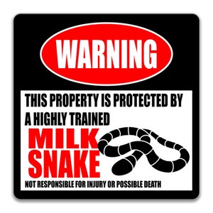 May include: A black and white warning sign with a red circle that says "WARNING" in white letters. The sign says "This property is protected by a highly trained milk snake. Not responsible for injury or possible death."