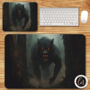 May include: A black mousepad and a matching rectangular desk mat featuring a menacing werewolf with glowing red eyes in a dark forest setting. A white keyboard and mouse are also present.