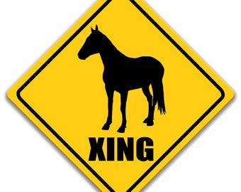 May include: Yellow diamond-shaped warning sign with a black silhouette of a horse and the word "XING" in black letters.