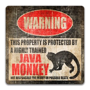 May include: A warning sign with a red circle and the word "WARNING" in white letters. The sign says "This property is protected by a highly trained JAVA MONKEY. Not responsible for injury or possible death." The sign has a distressed, vintage look and features a silhouette of a monkey.