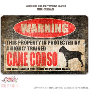 May include: A black and white warning sign with red text that reads "WARNING" in a circle. The sign says "This property is protected by a highly trained Cane Corso. Not responsible for injury or possible death."